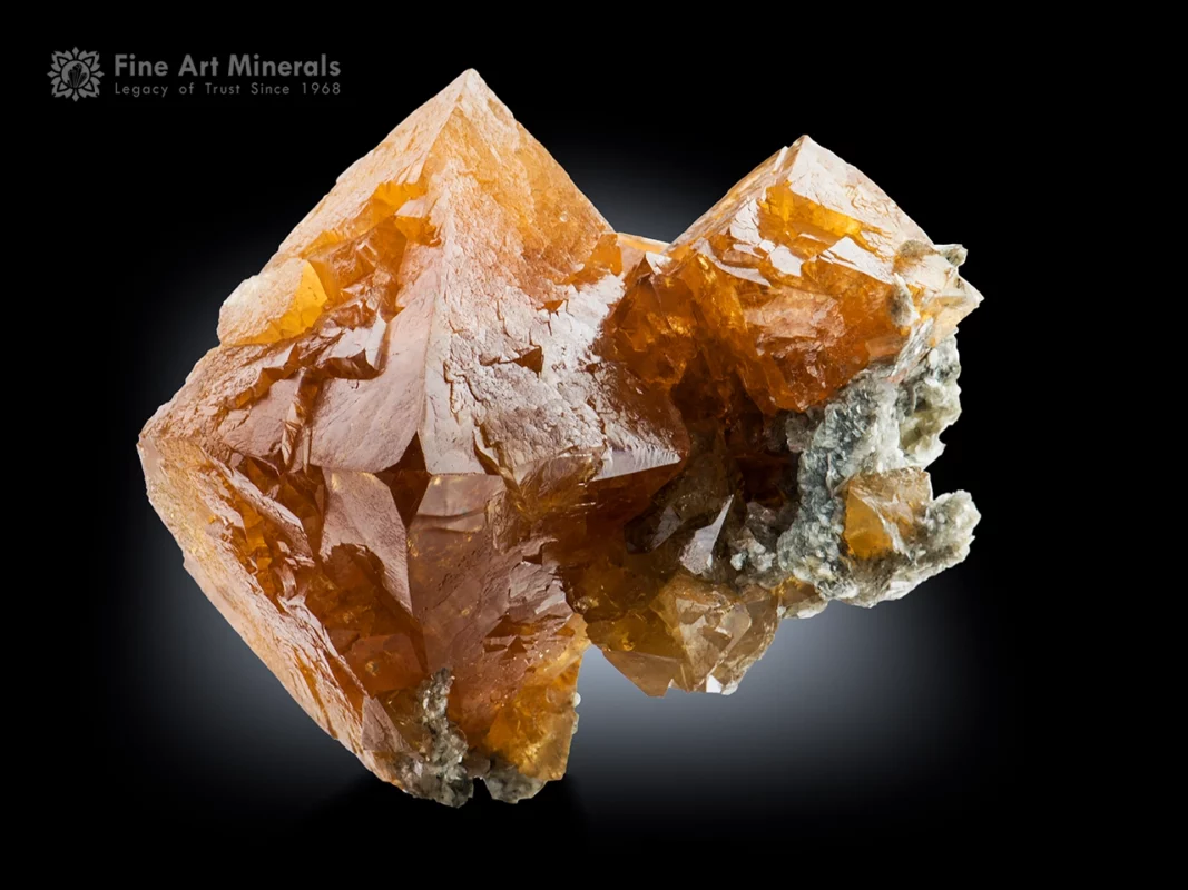 Lustrous scheelite crystal with sharp octahedral form and brilliant reflections on muscovite matrix from Mt. Xuebaoding, Pingwu County, China.