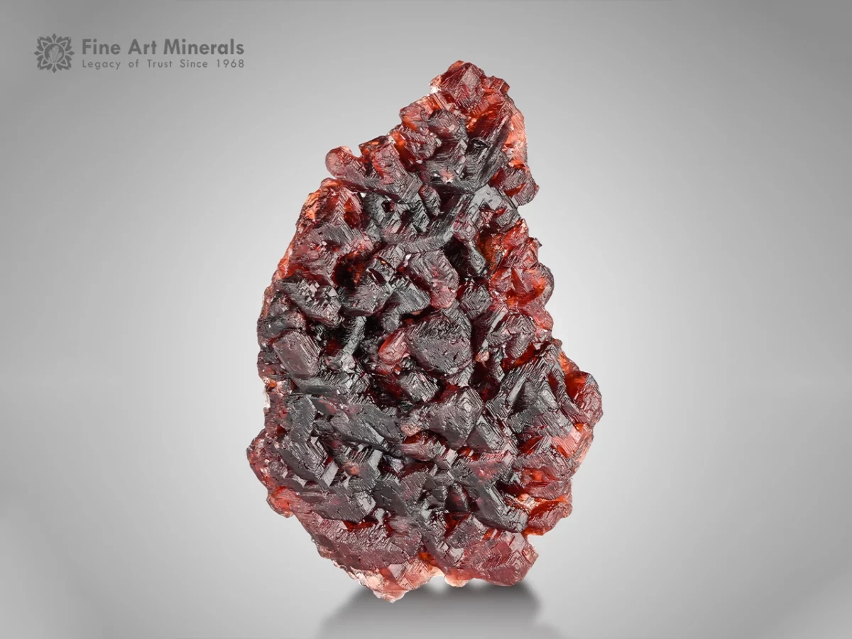 Spessartine Garnet from Shengus, Pakistan — small cabinet specimen with fiery red-orange color and etched surfaces.