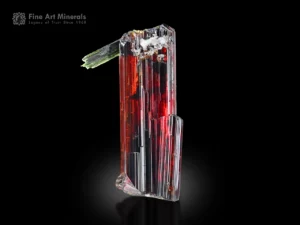 Single fiery red rutile crystal with green aegirine from Zagi Mountain, Pakistan, showing sharp striations and excellent luster.