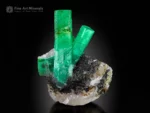 Emerald crystals from Garam Chashma, Pakistan — cabinet specimen with vivid green prisms up to 7.5 cm on matrix.