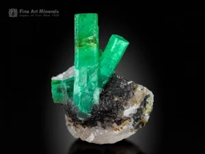 Emerald crystals from Garam Chashma, Pakistan — cabinet specimen with vivid green prisms up to 7.5 cm on matrix.