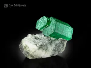 Green emerald crystal with pyrite on white and gray matrix from Swat, Pakistan.