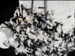 Large feldspar crystal with black schorl and quartz.