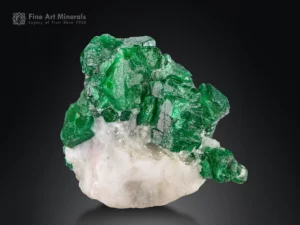 Fine emerald crystals with sharp hexagonal shape, bright luster, and vibrant green color on white matrix from Swat District, Pakistan