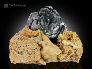 Hematite rosette crystal on albite matrix showing metallic luster and sharp form from Tormiq Valley, Pakistan.