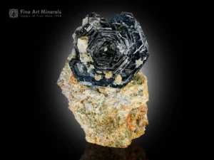 Hematite rosette crystal with metallic luster and albite contrast.