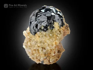 Metallic hematite crystal on albite matrix with sharp faces and bright luster from Tormiq Valley, Pakistan.