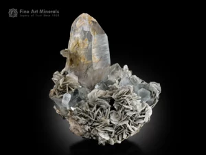 Quartz crystal with riebeckite inclusions, aquamarine, and muscovite rosettes from Skardu, Pakistan.