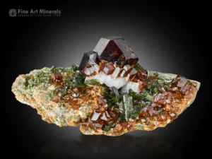 Andradite garnet crystals with feldspar and green epidote showing strong luster and sharp faces from Kharan, Balochistan, Pakistan.