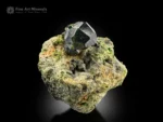 Dark green demantoid garnet crystal on a contrasting matrix from South Asia.