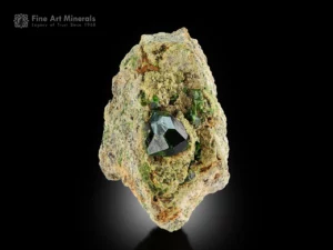 Bright green demantoid garnet with smaller crystals on a contrasting matrix