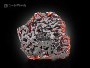 Deep red etched spessartine garnet from Shengus with reflective faces and vivid saturation.