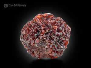 Deep red etched spessartine garnet with sharp reflective faces and rich color from Pakistan.