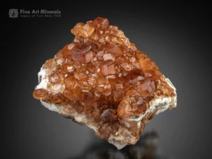 Bright cinnamon-orange grossular garnet crystals from the Jeffrey Mine, with sharp faces, intense luster, and excellent transparency.