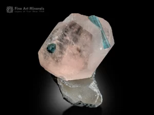 Peach-colored morganite crystal with embedded blue tourmaline on quartz matrix