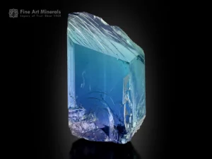 Natural kunzite crystal displaying vivid blue and green color zoning with bright clarity and textured termination.