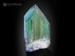 Natural kunzite crystal displaying vivid blue and green color zoning with bright clarity and textured termination.