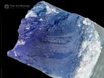 Natural kunzite crystal displaying vivid blue and green color zoning with bright clarity and textured termination.