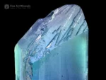 Natural kunzite crystal displaying vivid blue and green color zoning with bright clarity and textured termination.