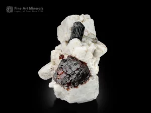 Spessartine garnet with schorl crystal on feldspar matrix, Pakistan.