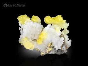 Yellow and white brucite specimen from Pakistan showing rounded clusters and bright contrast on the matrix.