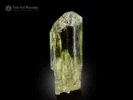 Transparent yellow spodumene var. triphane crystal with etched termination and glassy luster.