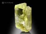 Translucent yellow triphane crystal from Afghanistan, glowing warmly under backlight with etched termination and broad prism faces.