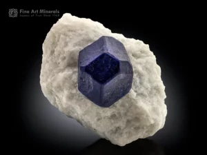 Sharp royal blue lazurite crystal on clean white marble from Afghanistan, showing strong geometry and classic aesthetic contrast.