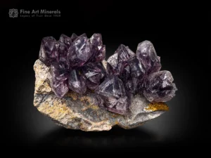 Fenster amethyst quartz cluster from the Brandberg area, Namibia, showing sharp crystals, rich purple color, and geometric window growth