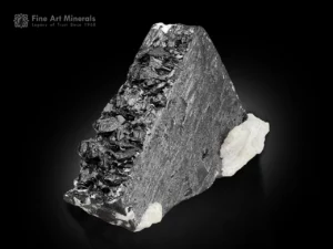 Columbite mn crystal with bright white albite matrix from Afghanistan, showing metallic luster and sharp crystal form