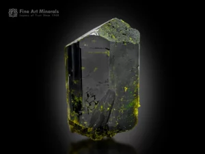 Dark epidote crystal from Pakistan showing vivid green flashes when backlit and strong vitreous luster.