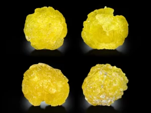 Lemon-yellow brucite crystals showing rounded natural shapes, vivid color, and bright, silky luster