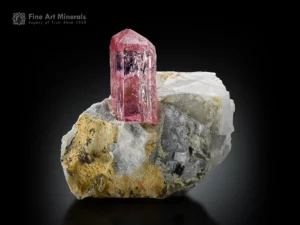 Gemmy pink topaz crystal on matrix from Pakistan with rich pink color and bright glassy luster.