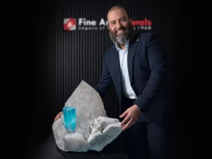 Blue aquamarine crystal growing from quartz and feldspar matrix mineral specimen