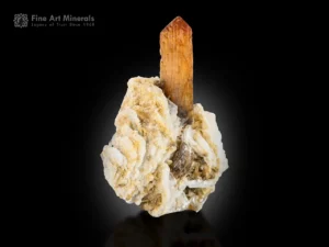 Amber brown monazite crystal on white albite matrix showing strong natural contrast