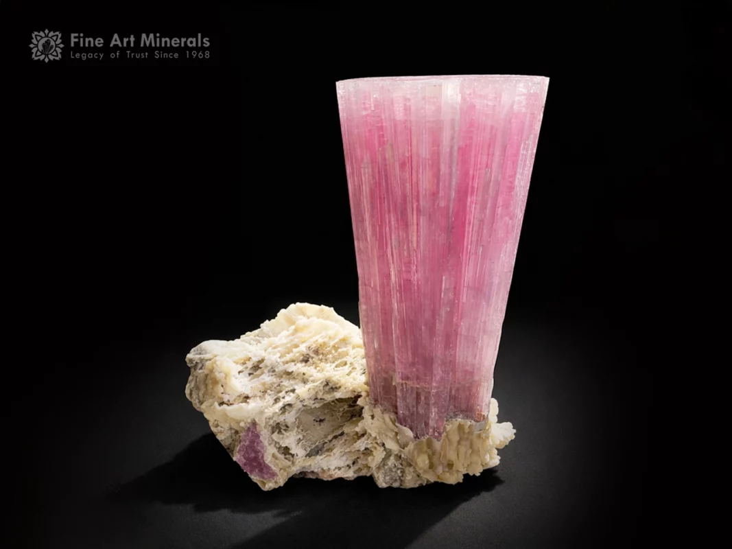 Pink tourmaline crystal on matrix with strong vertical striations and rich color.