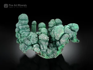 Green malachite towers rising from a malachite matrix with spires and peaks.