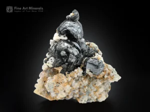 rounded hematite crystals with metallic luster on a contrasting matrix