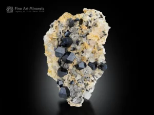 Lustrous black anatase crystals with bluish tones scattered on quartz and albite matrix.