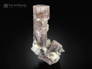 7 cm apatite crystal on albite matrix, glowing yellow under ultraviolet light.