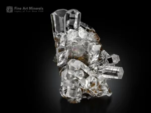 Calcite crystals with sharp prisms on dark pyrolusite matrix.