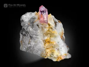 Transparent pink topaz crystal with sharp termination on quartz matrix.