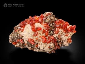 Vivid red rhodochrosite crystals on beige matrix from Peru with sharp lustrous terminations.