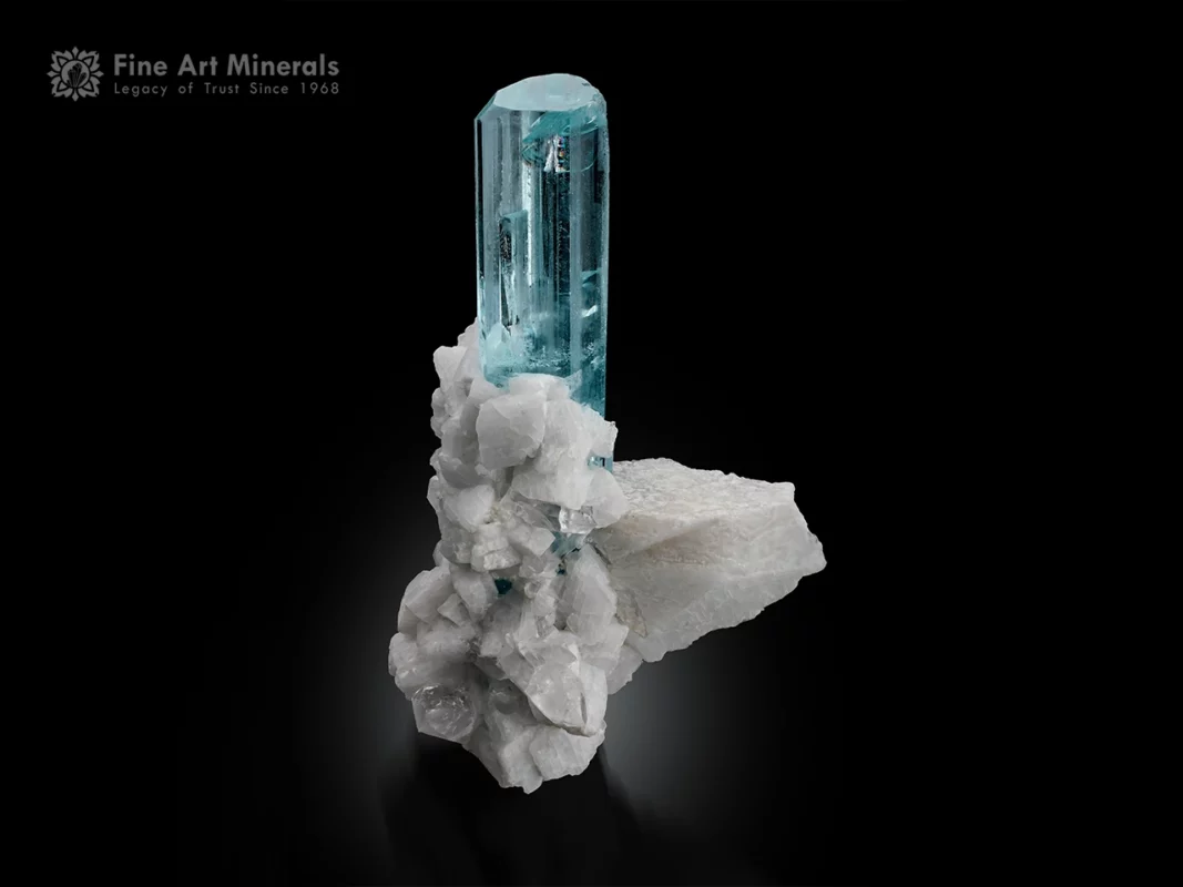 10 cm aquamarine crystal with flat termination on feldspar and quartz matrix with columbite inclusion.