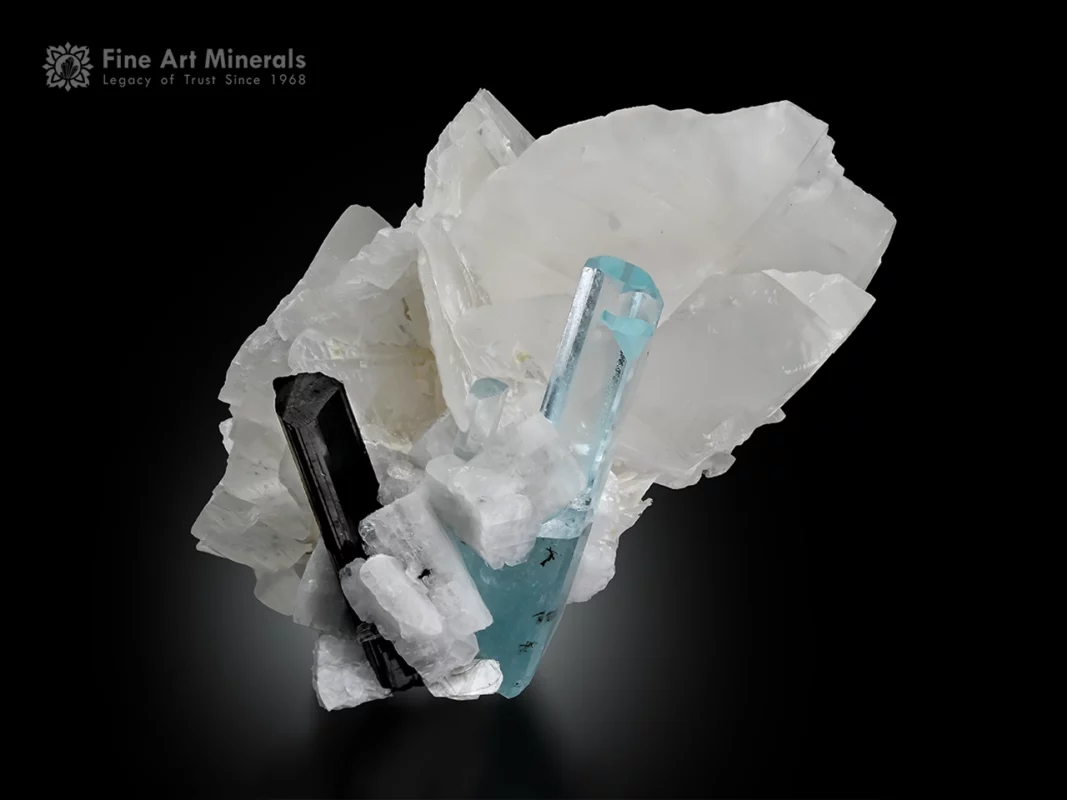 Blue aquamarine crystal with black schorl on white quartz and albite matrix.