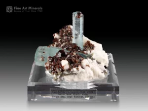 Sky blue aquamarine crystals with red garnet on matrix from Pakistan.