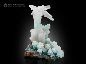 White aragonite crystal cluster rising over blue green chrysocolla on limonite matrix