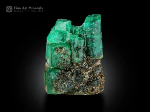 Green emerald crystal cluster on muscovite matrix, with bright luster and natural contrast.