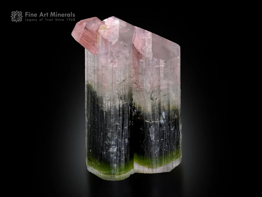 Bi-color tourmaline crystal with pink top and green base showing vertical striations.