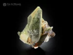 Brookite crystal associated with elongated chlorite-included quartz with sharp termination and natural contrast.
